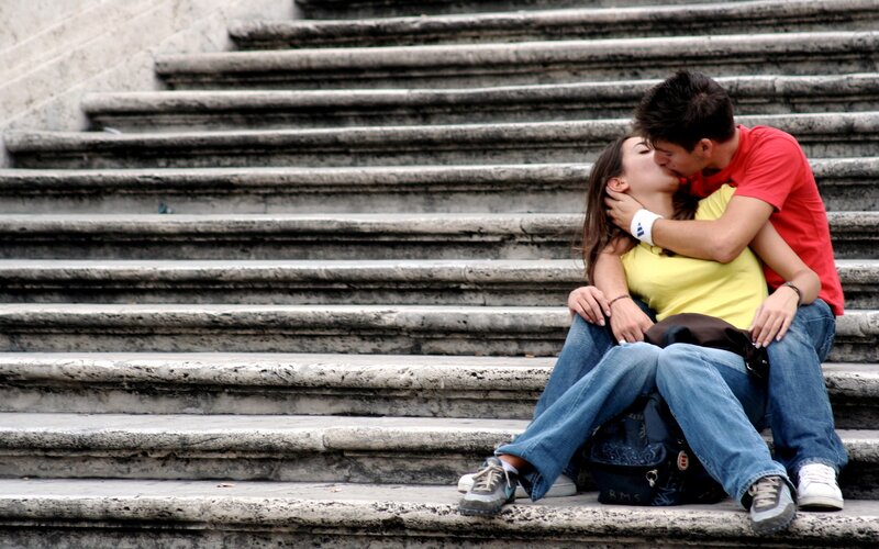 couple kissing on stairs
