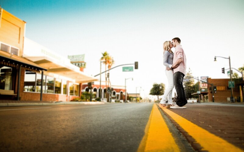 couple kissing on street corner