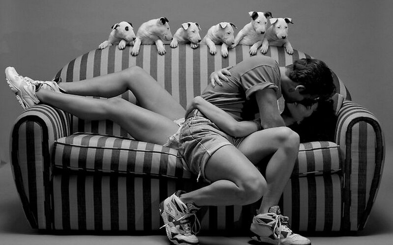 Couple kissing on striped couch