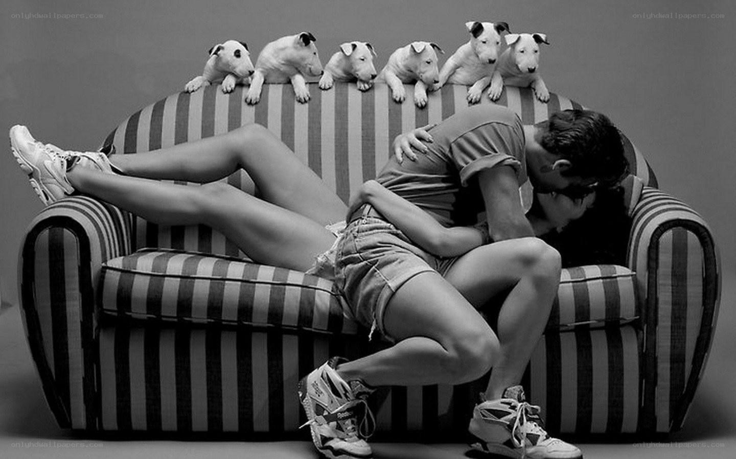 Couple kissing on striped couch
