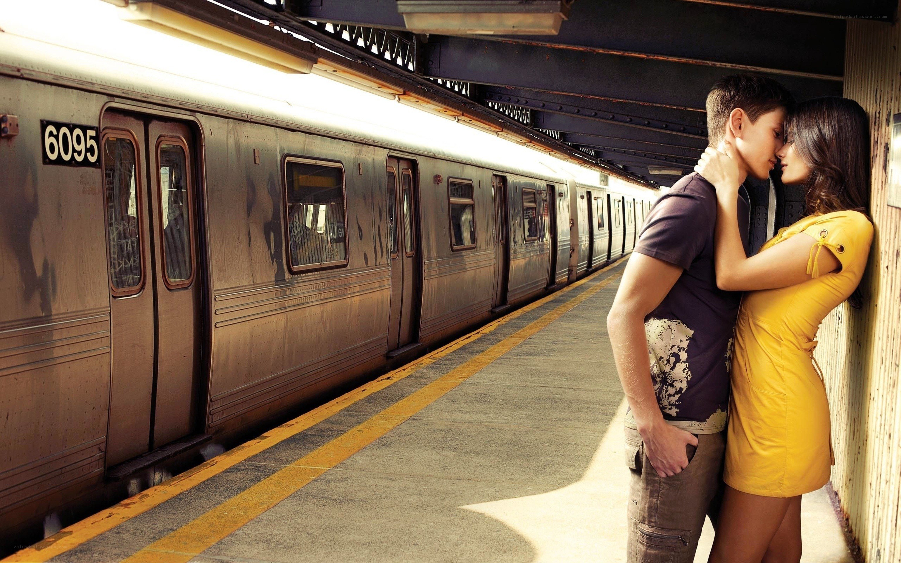 Couple kissing on subway platform