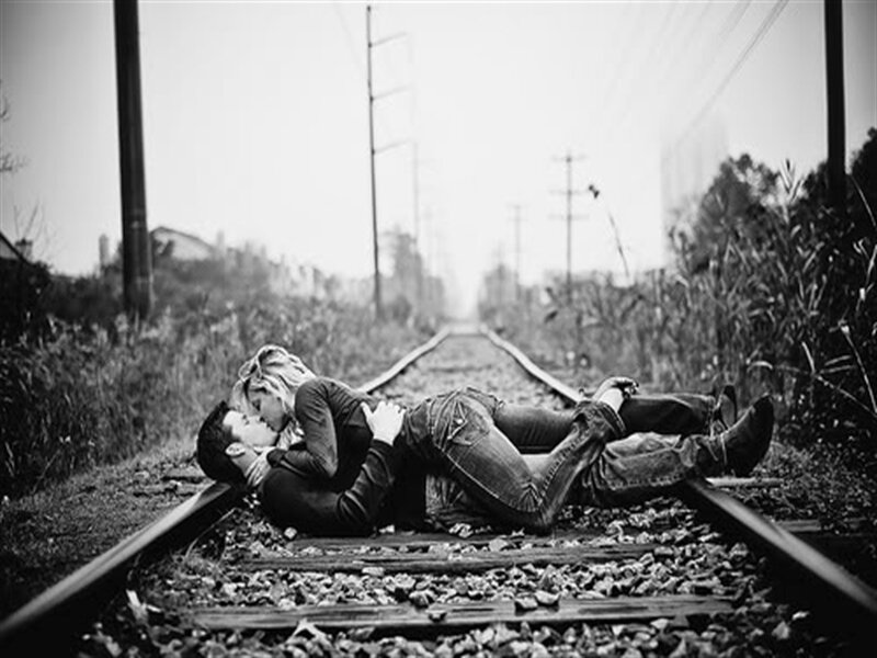 Couple Kissing on Train Tracks