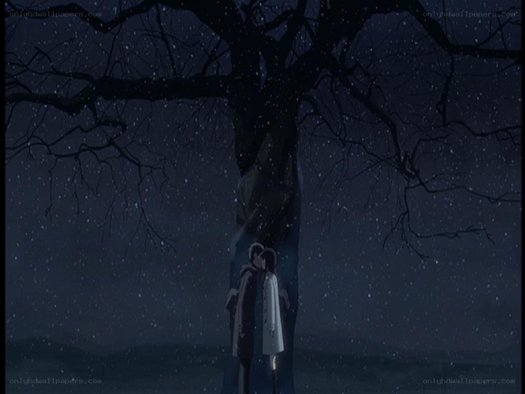 couple kissing under a tree