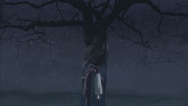 couple kissing under a tree