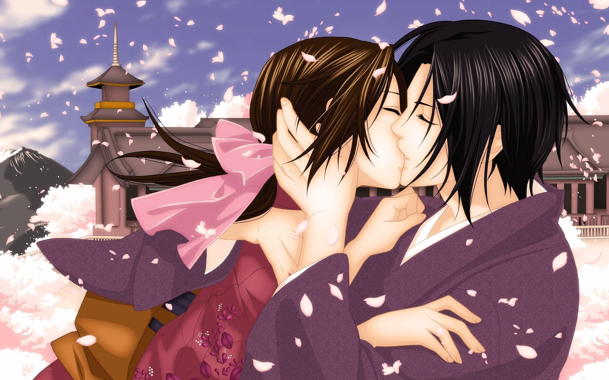 couple kissing under cherry blossoms