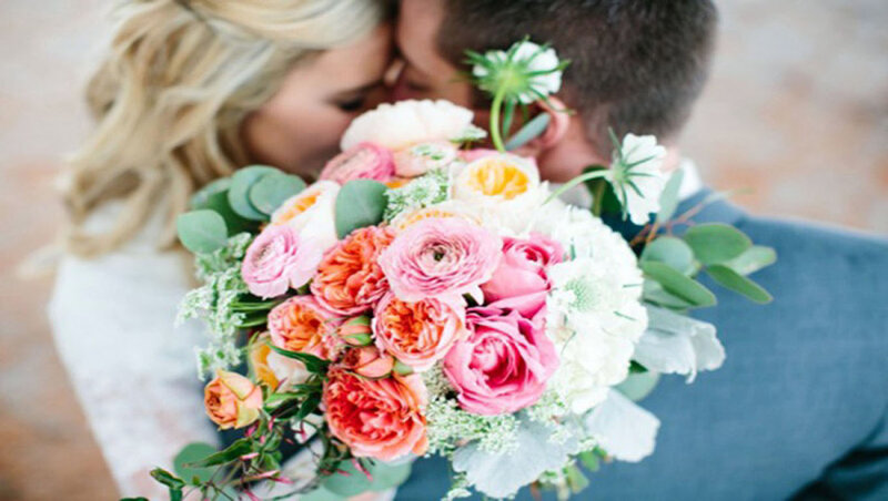 Couple Kissing with Bouquet