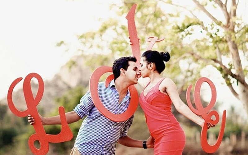 Couple Kissing with Love Sign