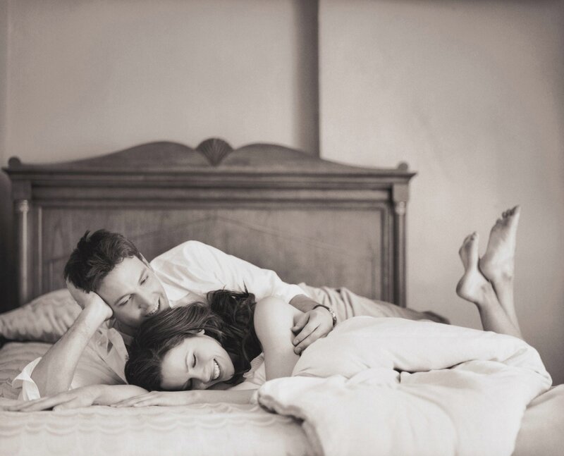 Couple laughing in bed