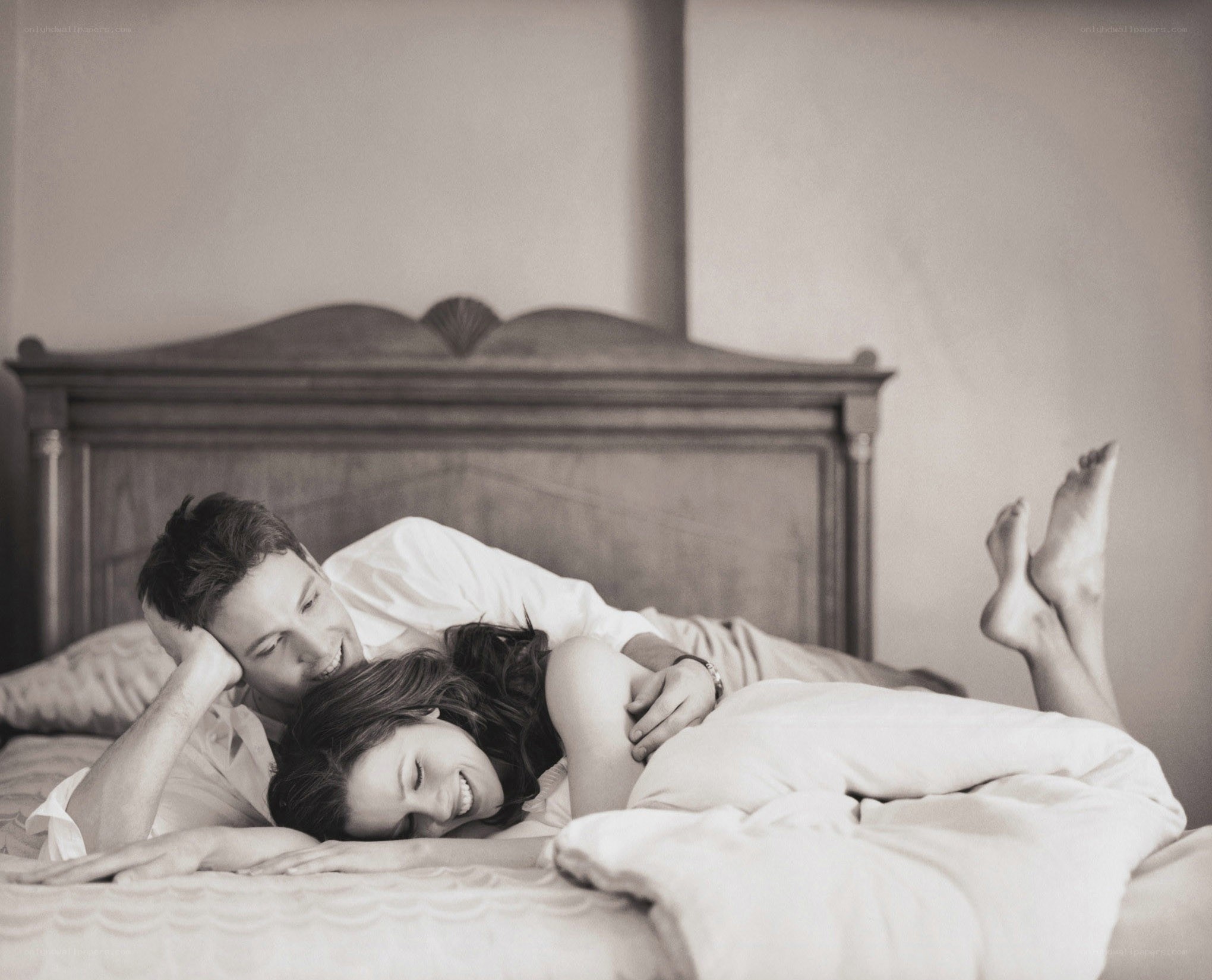 Couple laughing in bed
