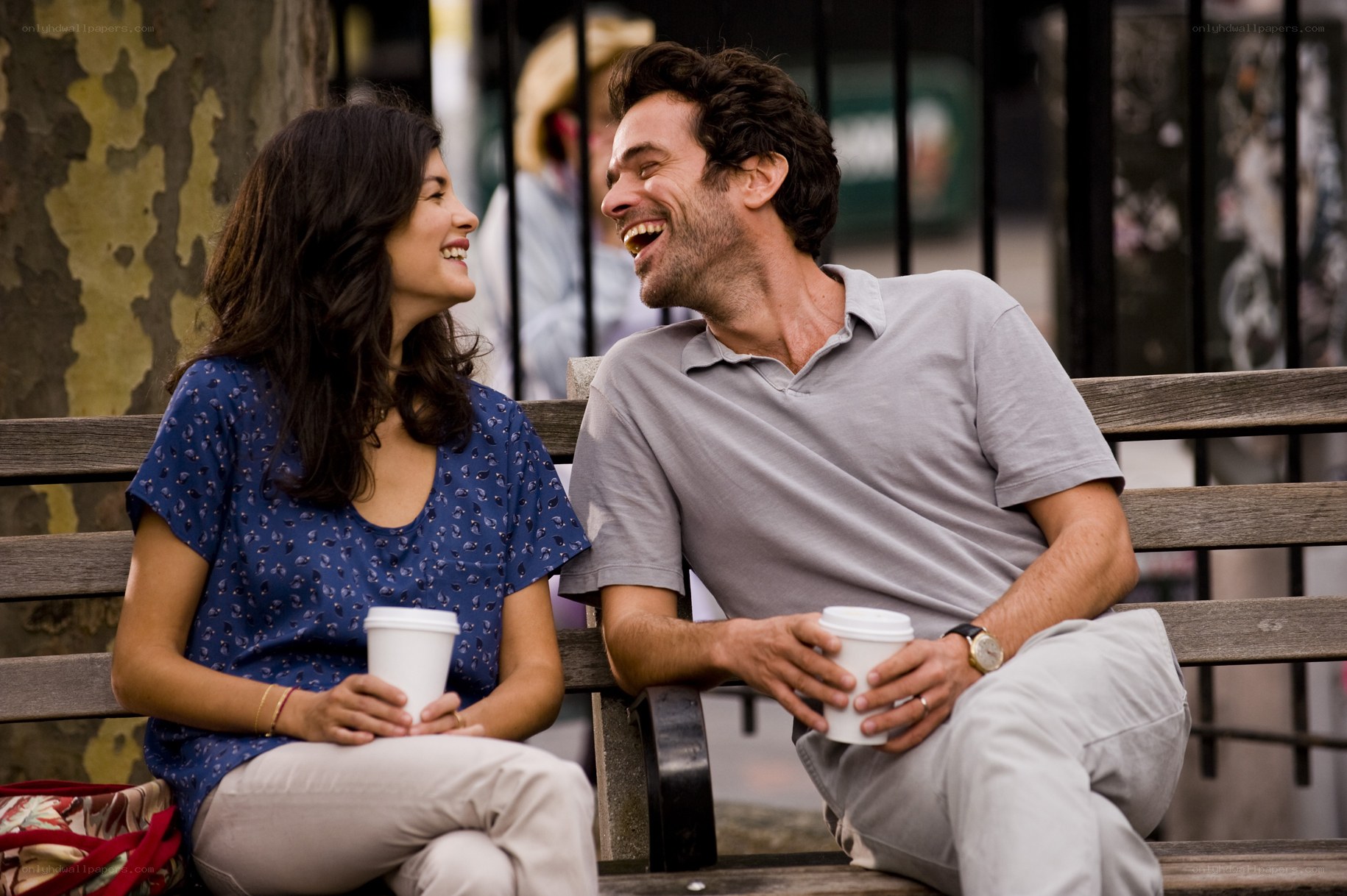 Couple laughing on a bench