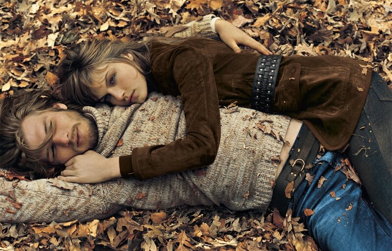 couple lying in autumn leaves