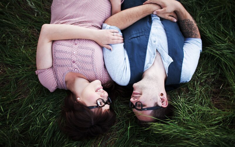 Couple Lying in Grass — Green, Peaceful, Afternoon, Photograph, Glasses