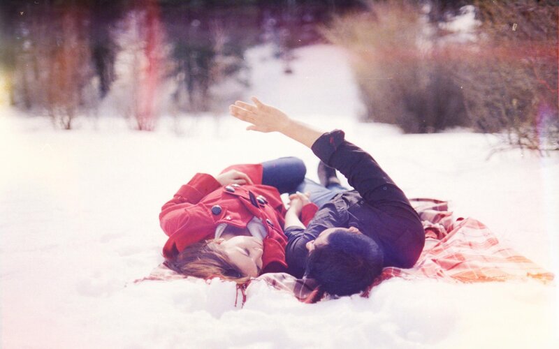 Couple Lying in Snow — White, Peaceful