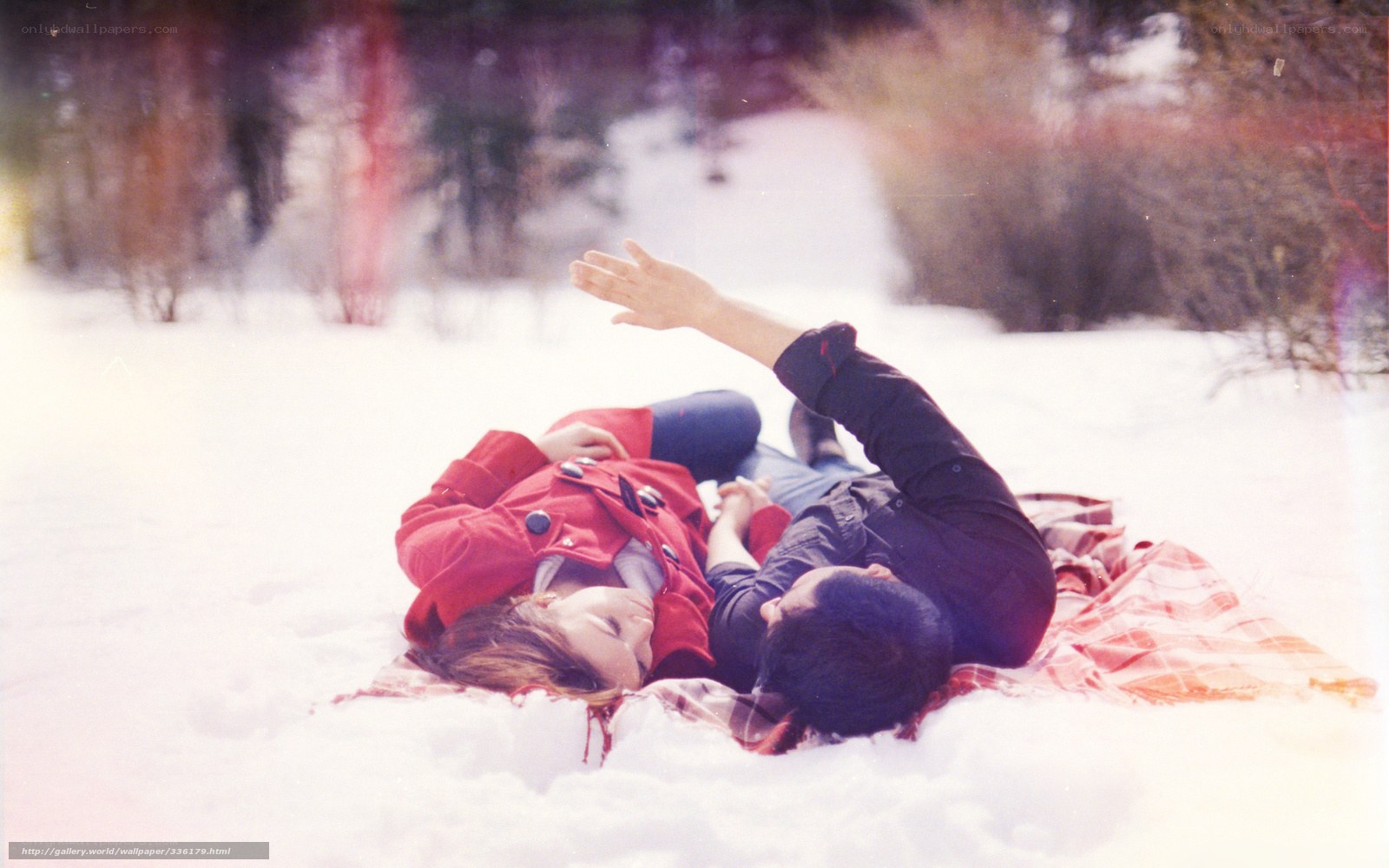 Couple lying in snow