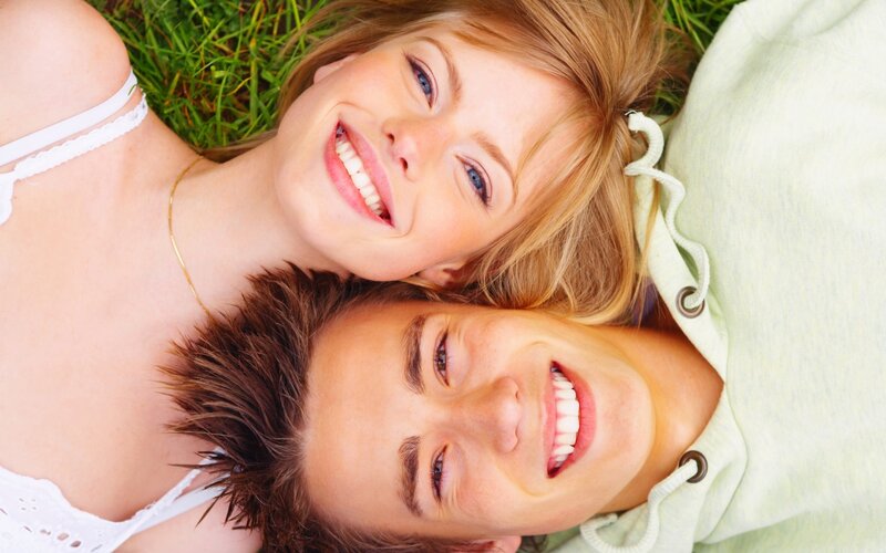 Couple Lying on Grass — Green, Happy, Afternoon, Photograph, Sweatshirt