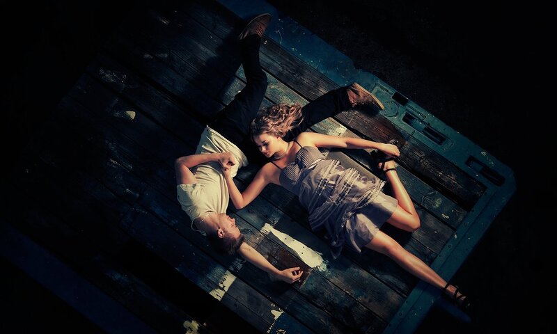Couple lying on wooden deck