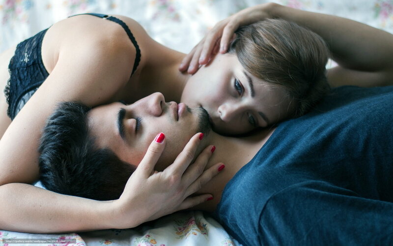 Couple lying together on bed
