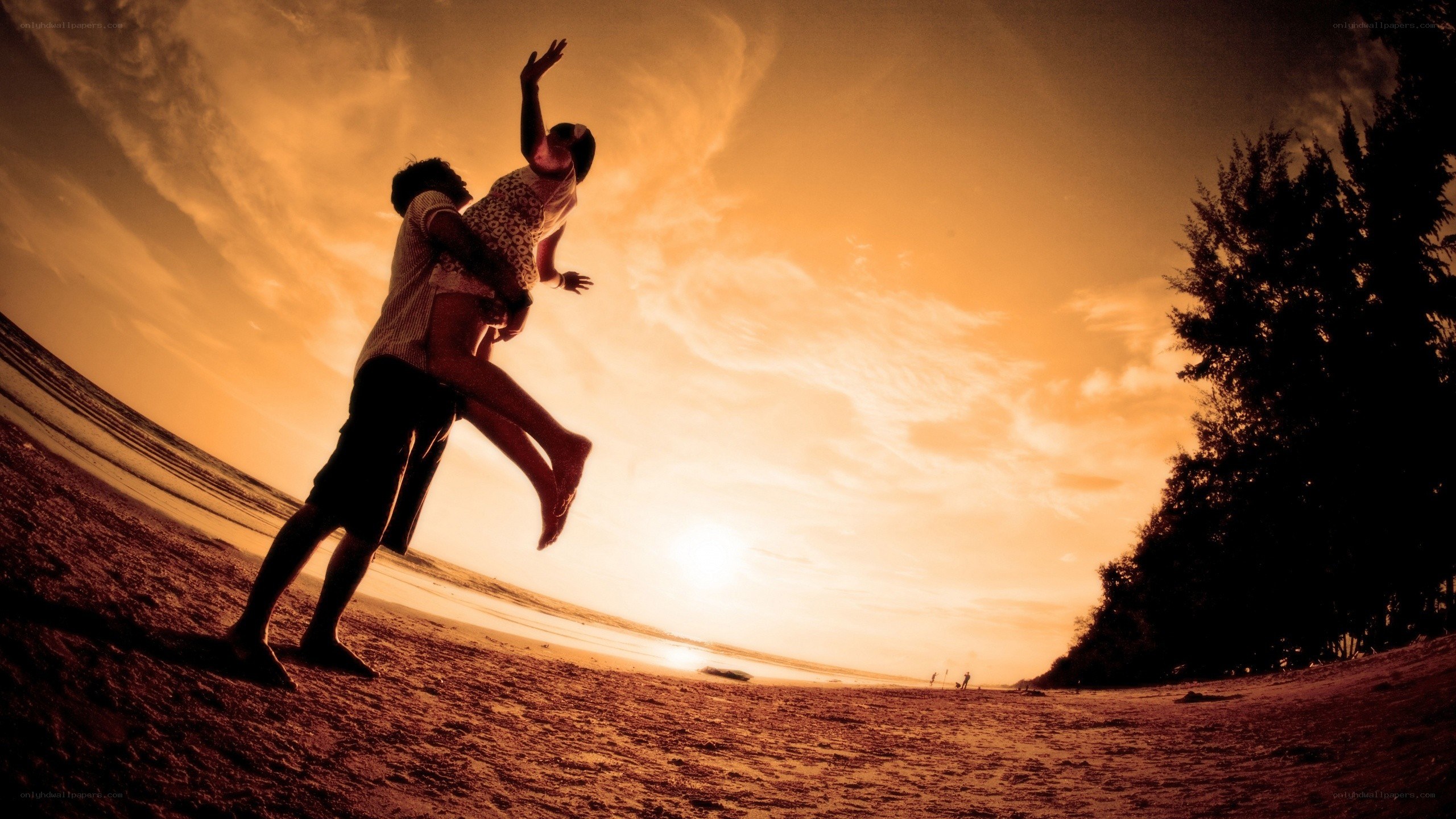 Couple on a beach at sunset