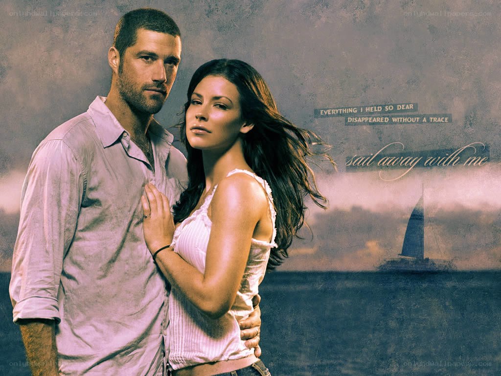 couple on a beach with sailboat