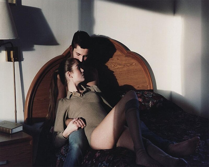 Couple on a bed in soft light