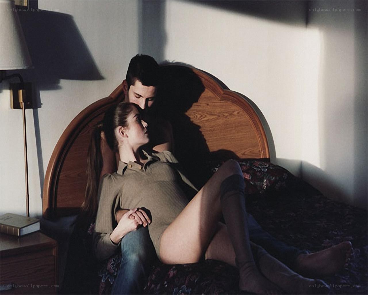 Couple on a bed in soft light