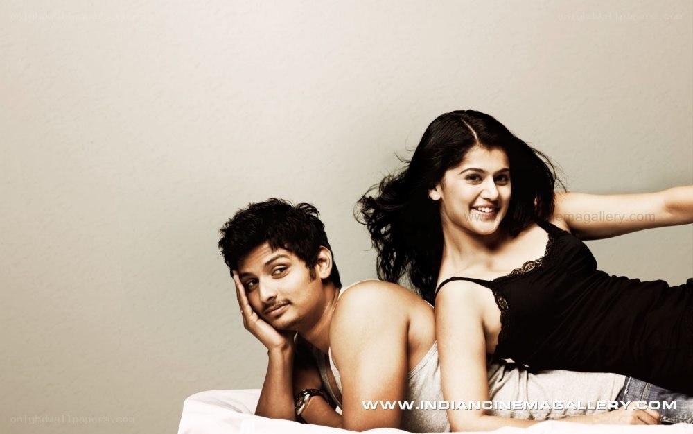 couple on a bed smiling