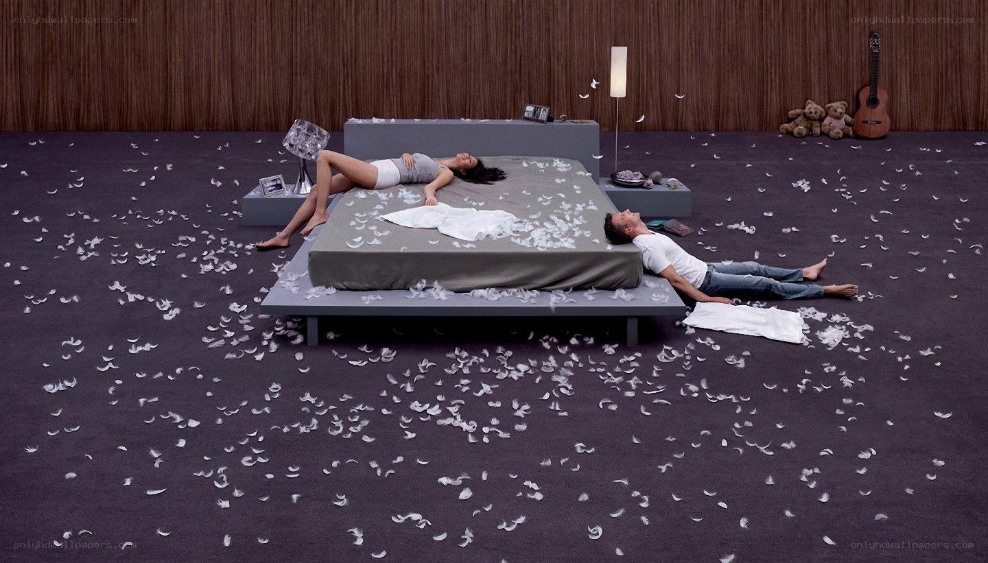 Couple on a bed with feathers