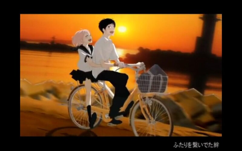 Couple on a bike at sunset