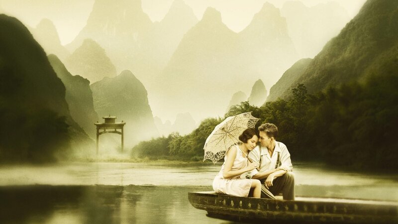 Couple on a boat in misty mountains