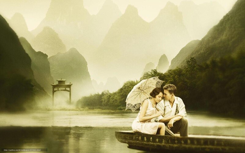 Couple on a boat in misty mountains