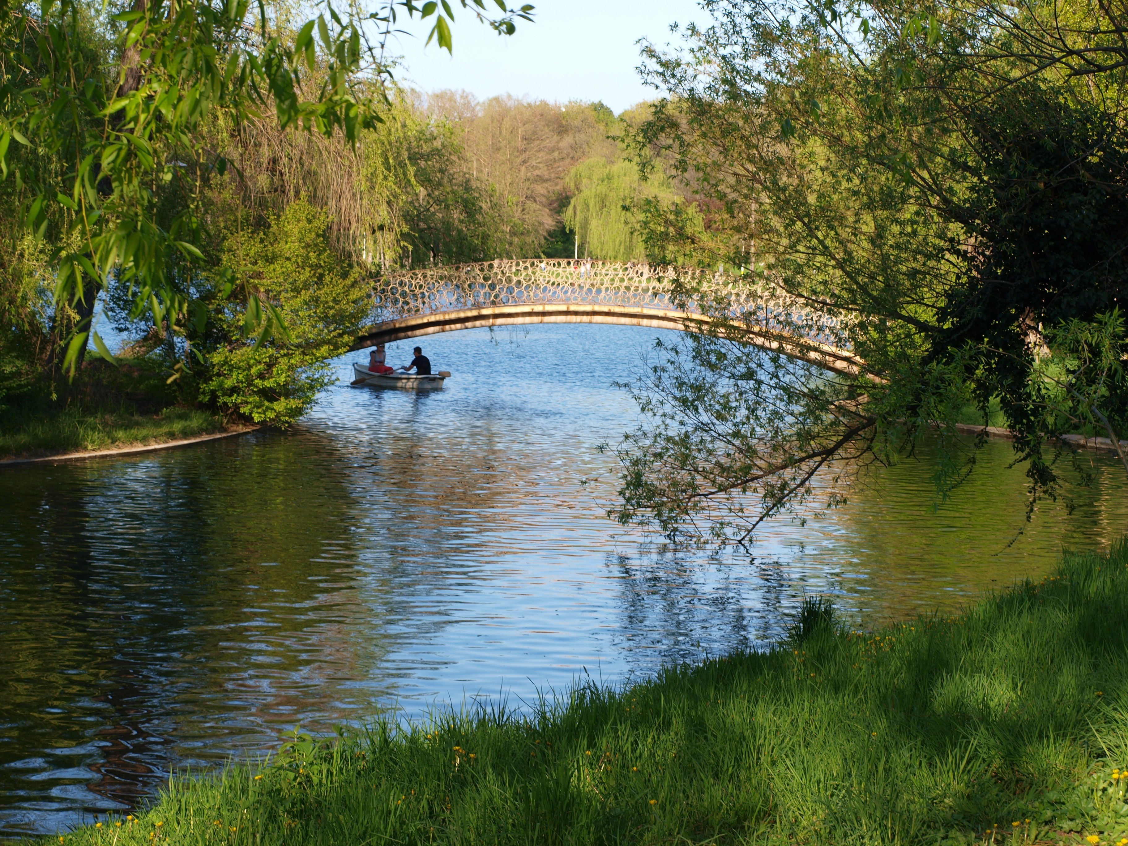 Couple on a boat under a bridge