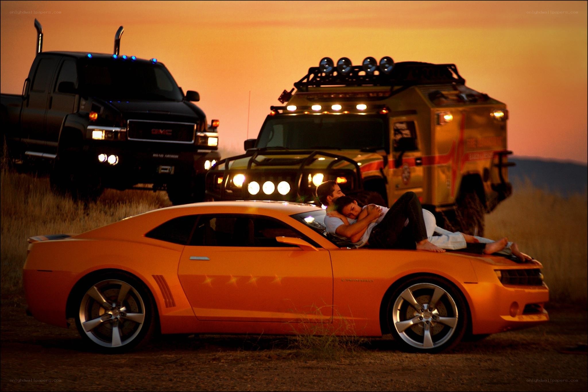 Couple on a car at sunset