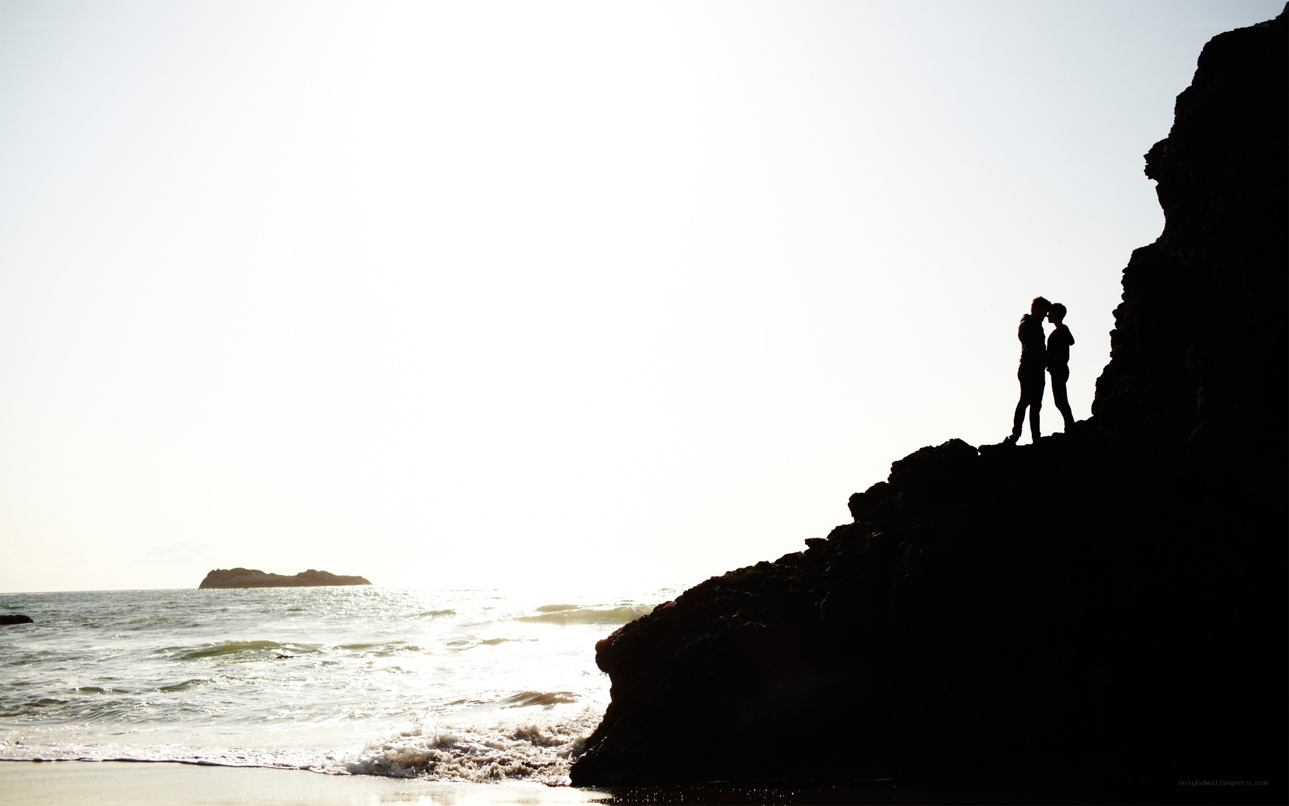 Couple on a cliff at sunset