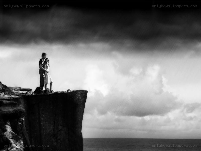 Couple on a cliff in the rain