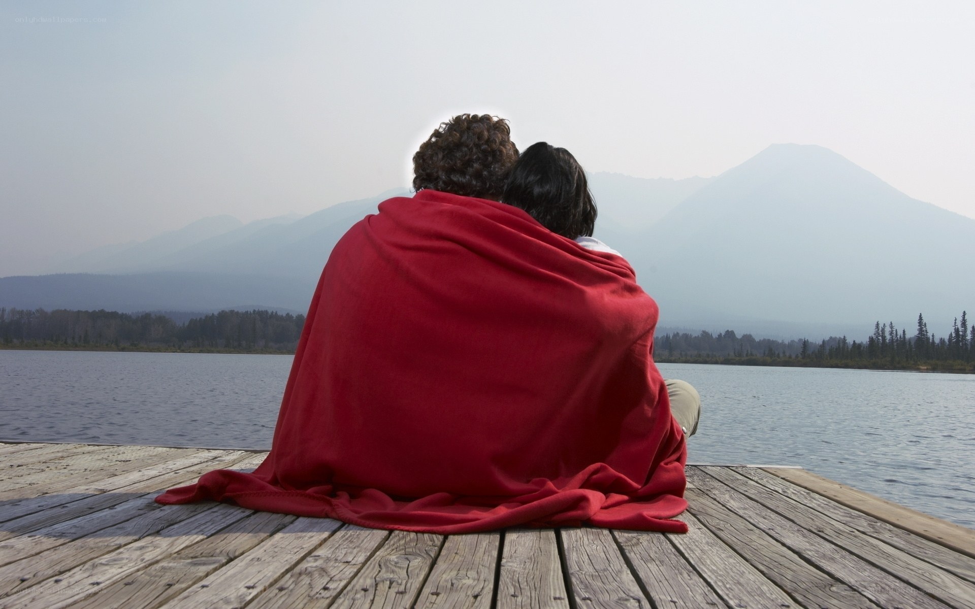 Couple on a dock with mountains