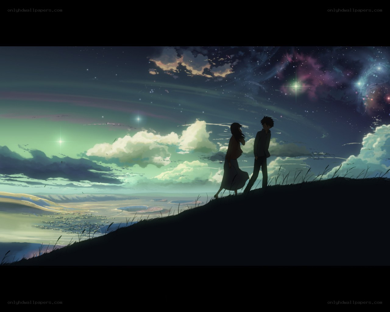 couple on a hill at night