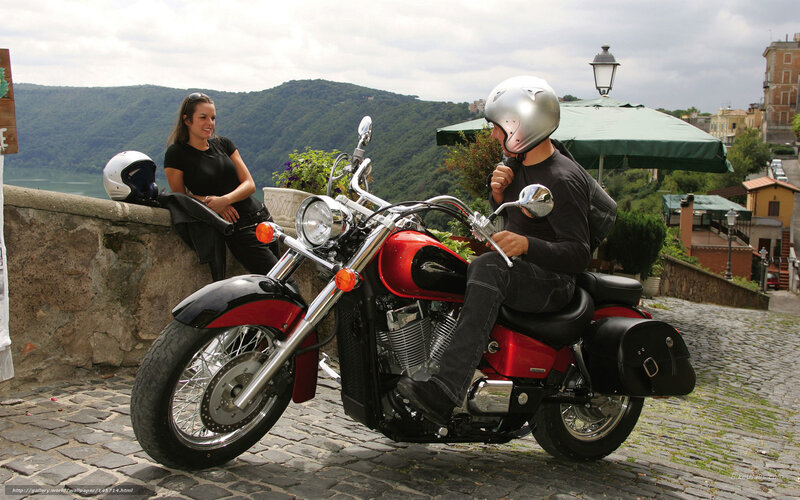 Couple on a motorcycle in a scenic town
