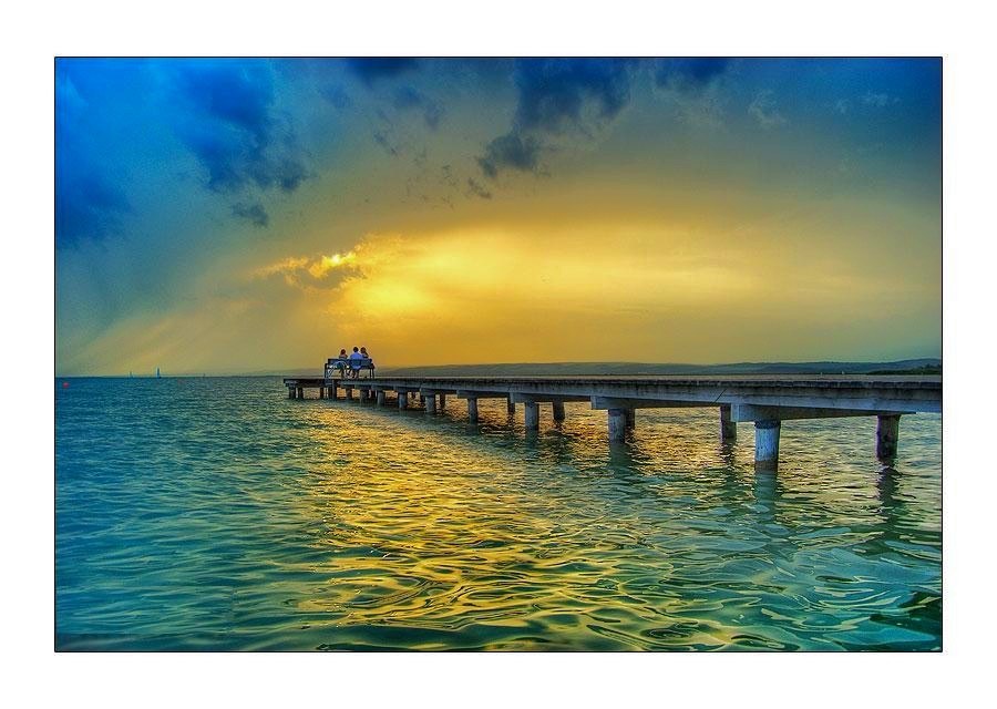 Couple on a pier at sunset