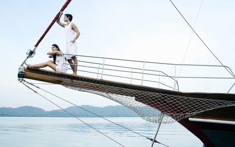 Couple on a sailboat bow