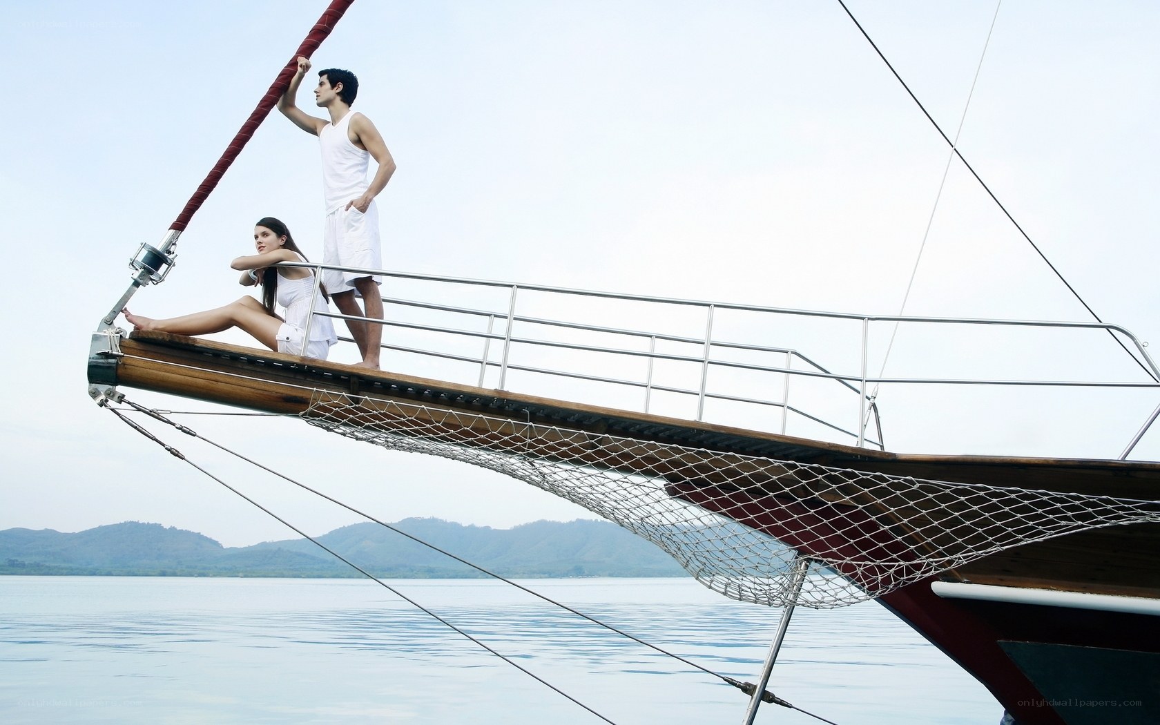 Couple on a sailboat bow