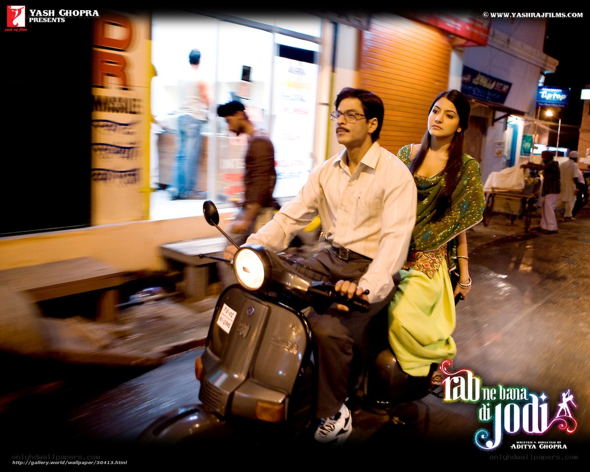 Couple on a scooter at night