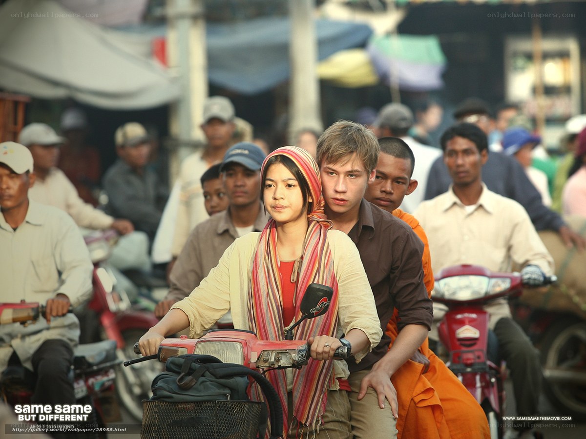 Couple on a scooter in a busy market