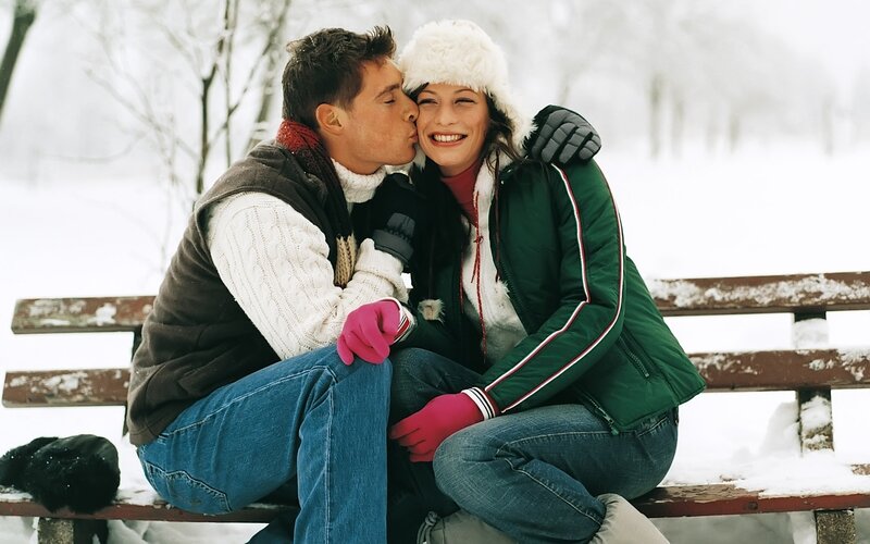 Couple on a snowy bench