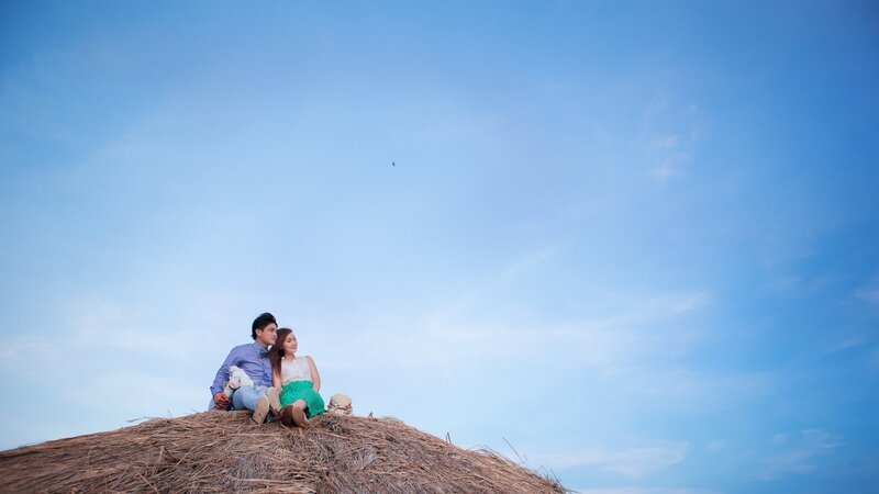 Couple on a thatched roof