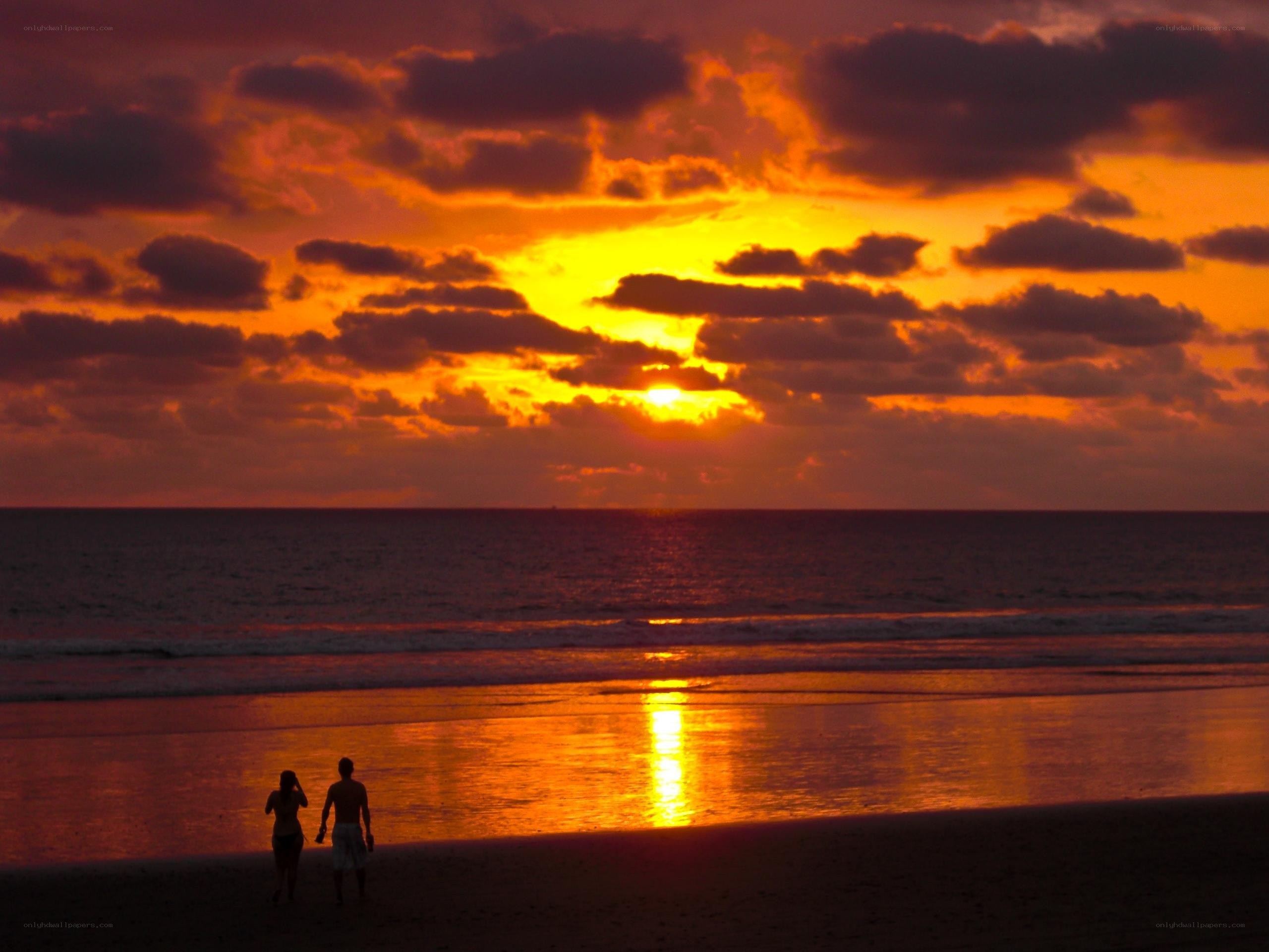 Couple on beach at sunset
