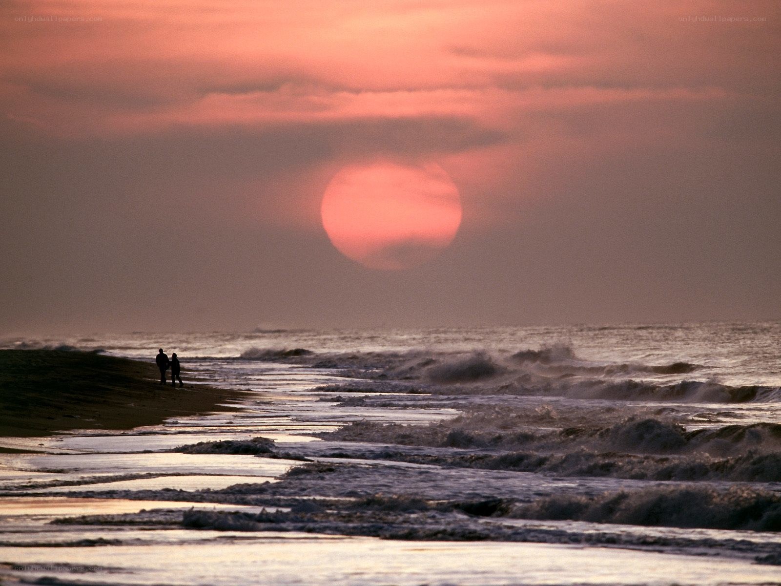 Couple on beach at sunset
