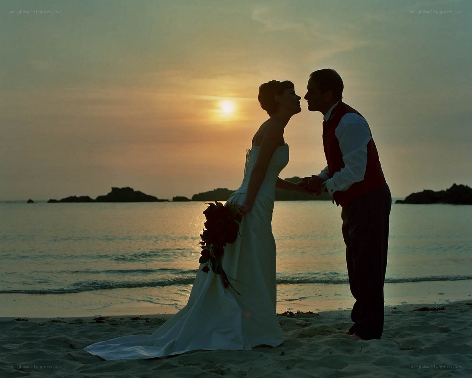 Couple on beach at sunset