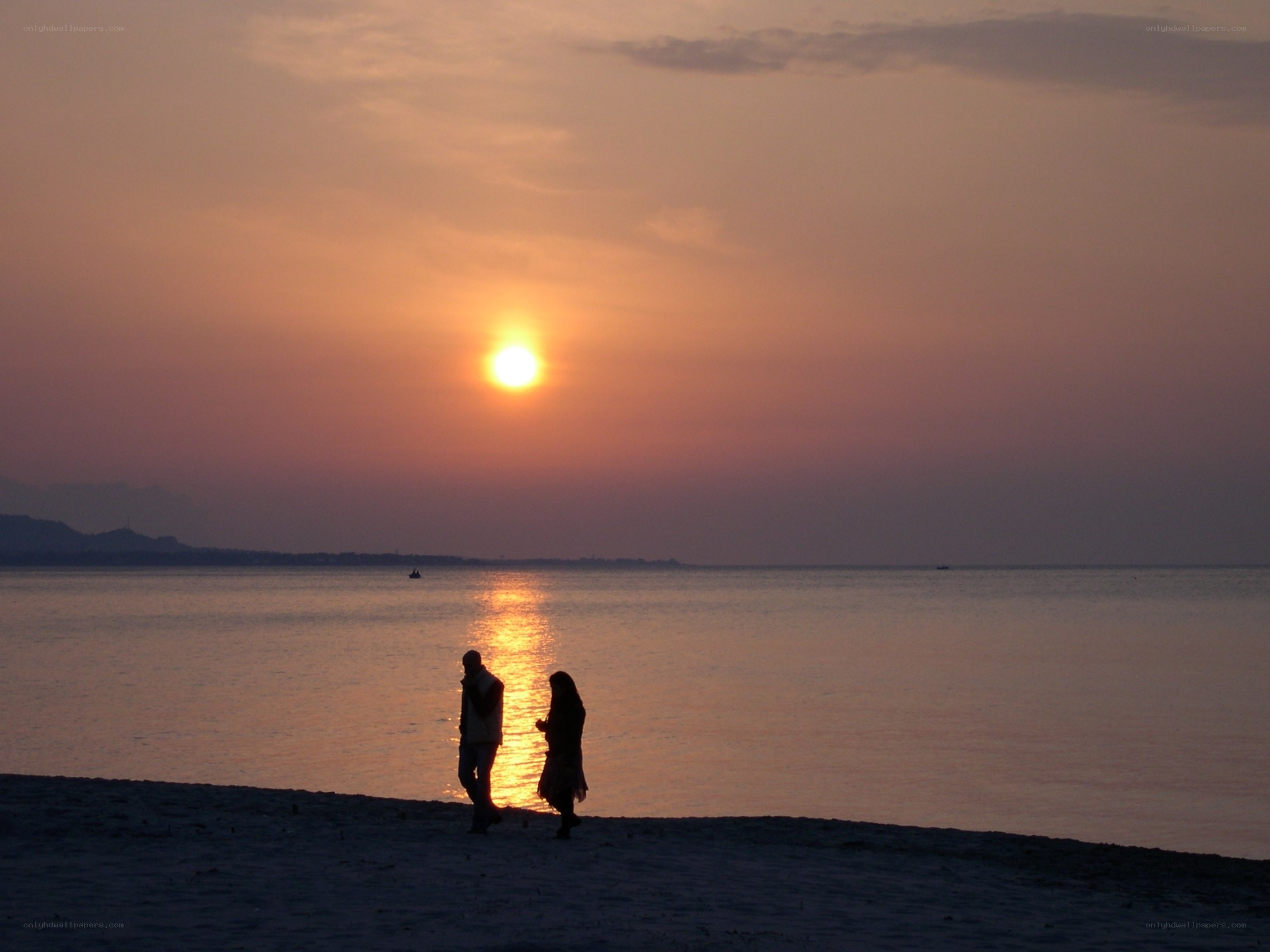 Couple on beach at sunset