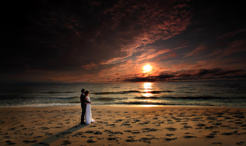 Couple on Beach at Sunset — Orange, Dramatic, Photograph