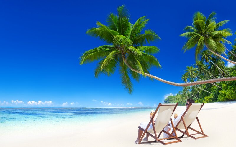 Couple on Beach Chairs — Blue, Relaxed, Afternoon, Photograph, Palm Trees